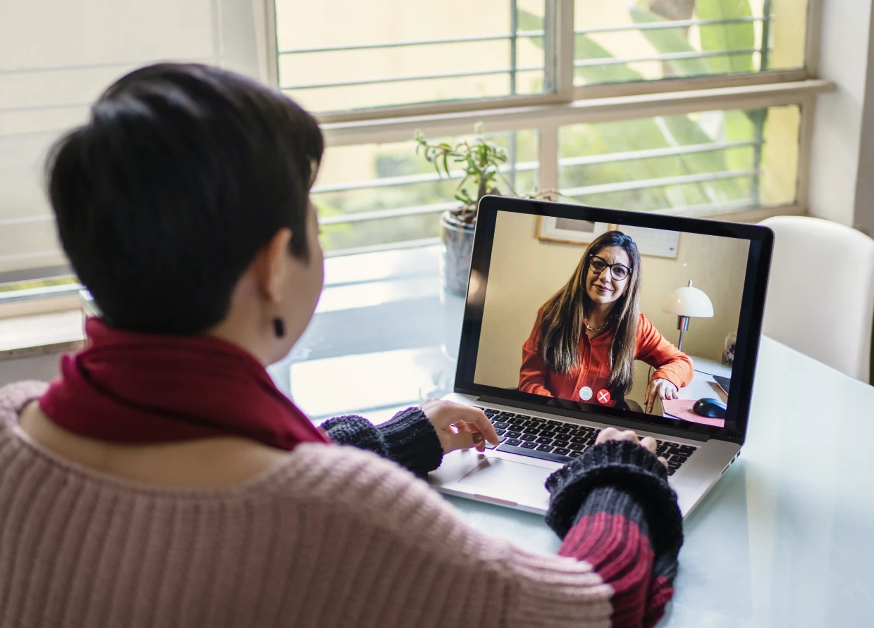 Woman in virtual meeting on computer